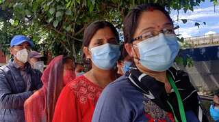Nepalis wait in long queues to receive Chinese COVID-19 vaccines