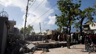 Storm brings floods as Haitians seek help at overloaded hospitals after quake