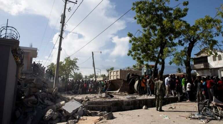 Storm brings floods as Haitians seek help at overloaded hospitals after quake