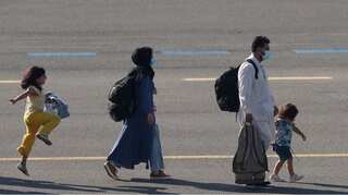 Yellow and smiles: Young Afghan girl seen skipping out of happiness after leaving Taliban regime