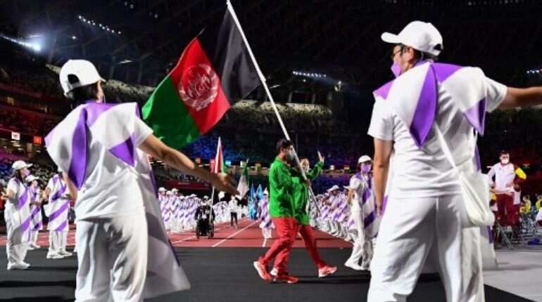 Athletes carry their nations' flags
