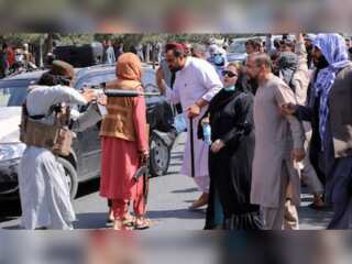 Taliban fighter points gun at Afghan woman protesting against non-inclusive government