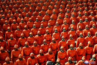 Coronavirus effect: North Koreans parade on National Day wearing hazmat suits