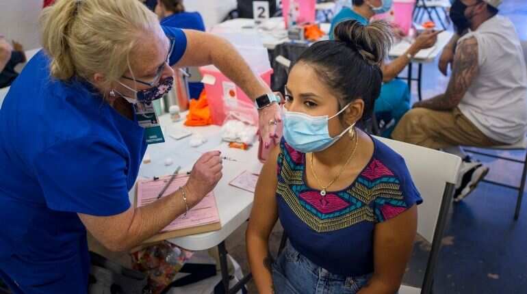 US mandates compulsory Covid jabs or weekly tests for private sector workers from January