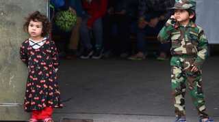 Military bases turn into small cities as Afghans wait months for homes in US