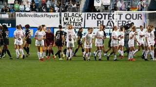 'No more silence': NWSL players stop match to link arms in solidarity after sexual misconduct allegations