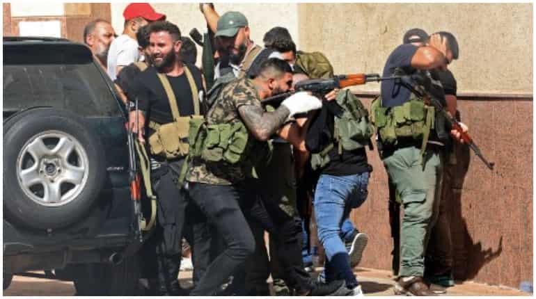 Chaos at Beirut protest rally as gunfire erupts claiming lives Chaos at Beirut protest rally as gunfire erupts claiming lives