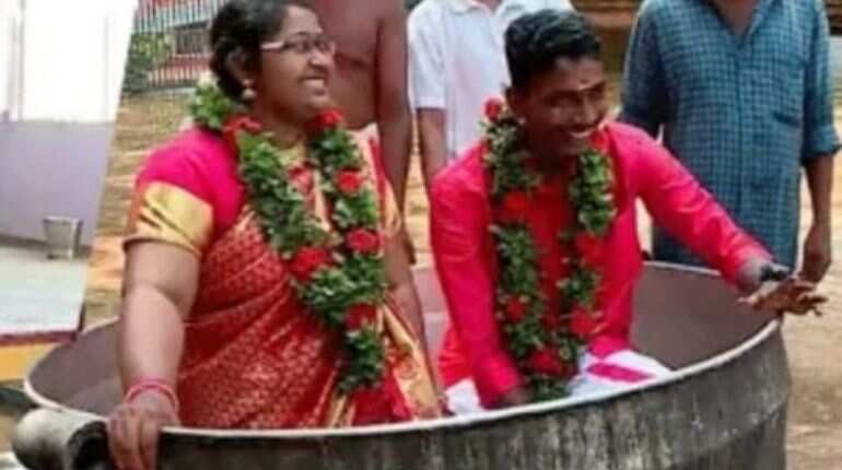 Indian couple wade through floodwater in ‘improvised vessel’ to tie the knot, braving all elements