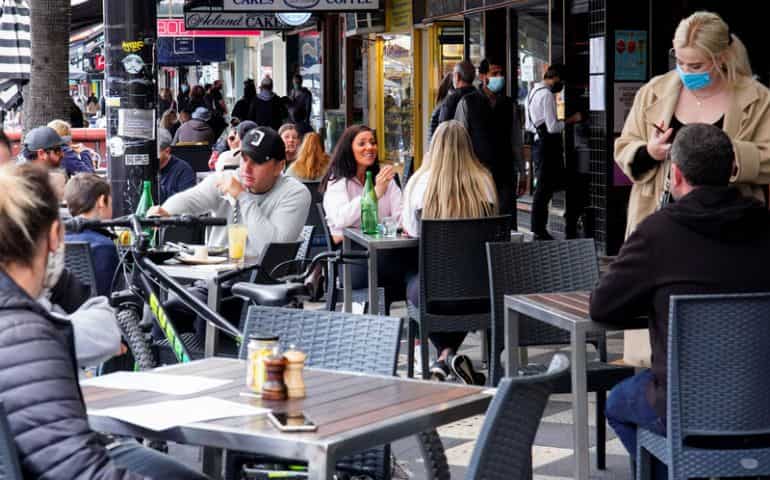 Australia's Melbourne back to the races, shops as vaccination rate hits 80%