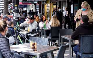 Australia's Melbourne back to the races, shops as vaccination rate hits 80%