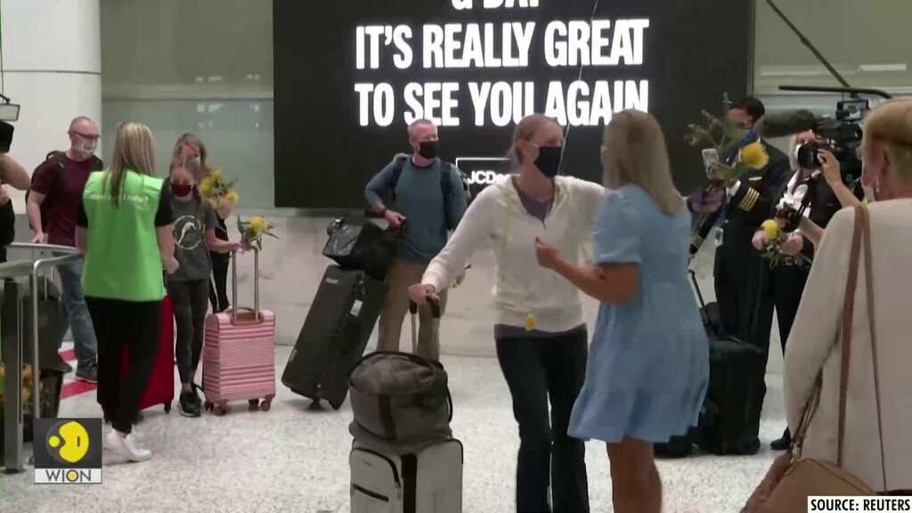 Emotional reunions at Sydney airport as Australia lifts travel ban