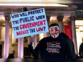 In Pics | Demonstrators wearing Guy Fawkes-style masks gather at Trafalgar Square in London
