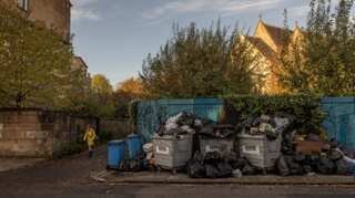 Outside climate summit, trash in Glasgow piles high