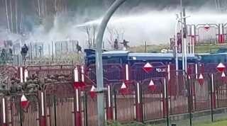 Polish forces use tear gas, water cannons on migrants at border