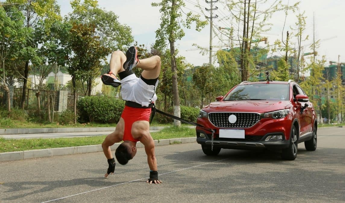 Fastest time to pull a car 50 metres walking on hands