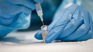 Will the vaccines stop Omicron? Scientists are racing to find out.