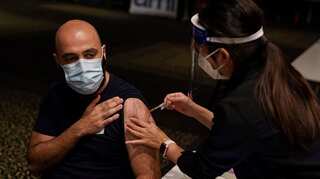 Australia relaxes testing rules amid Omicron surge