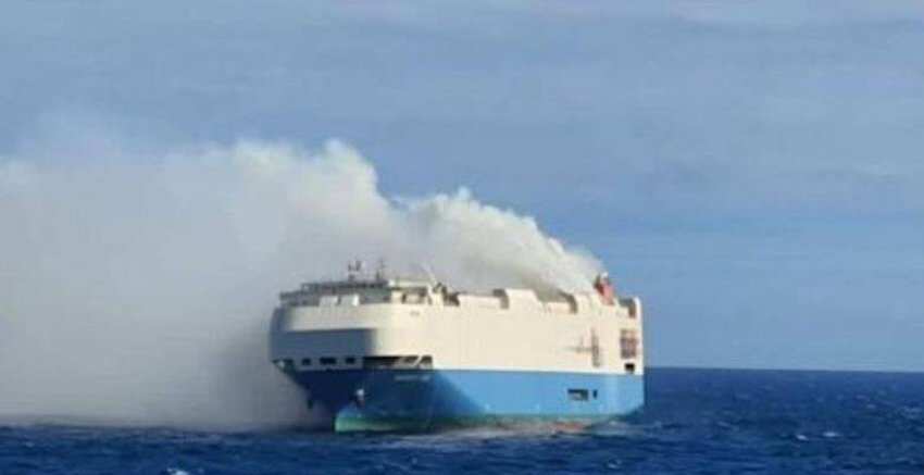 A burning cargo ship, consisting luxury cars, is adrift in mid-Atlantic
