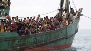 Rohingya boat with dozens of children lands in Indonesia's Aceh