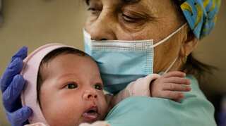 In a Kyiv basement, 19 surrogate babies are trapped by war but kept alive by nannies