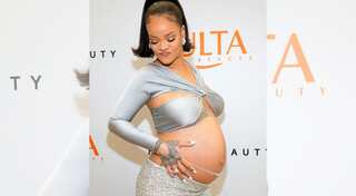 Rihanna sparkles in silver ensemble while flaunting her belly at Fenty Beauty event