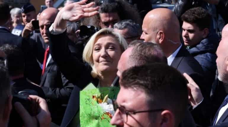 Marine Le Pen greets crowd outside polling station