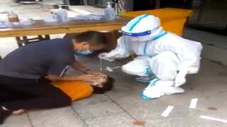Chinese woman pinned down as healthcare workers forcibly conduct COVID-19 test - WATCH