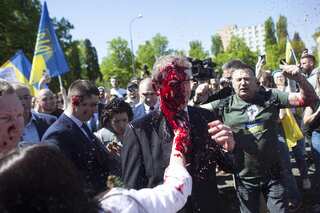 Anti-war protesters throw red paint on Russia's ambassador to Poland