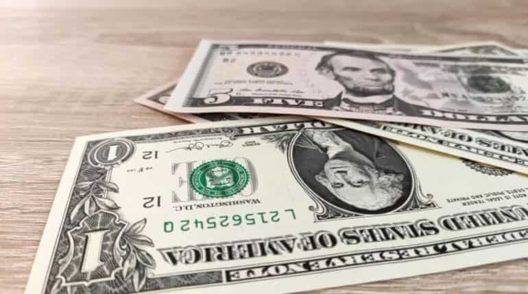Dollar slips from 2-decade highs; yuan falls on weak China data