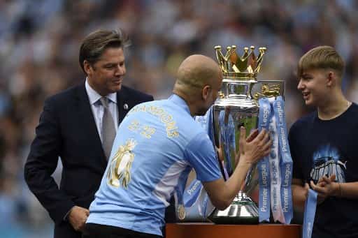 Pep Guardiola with the Premier League trophy