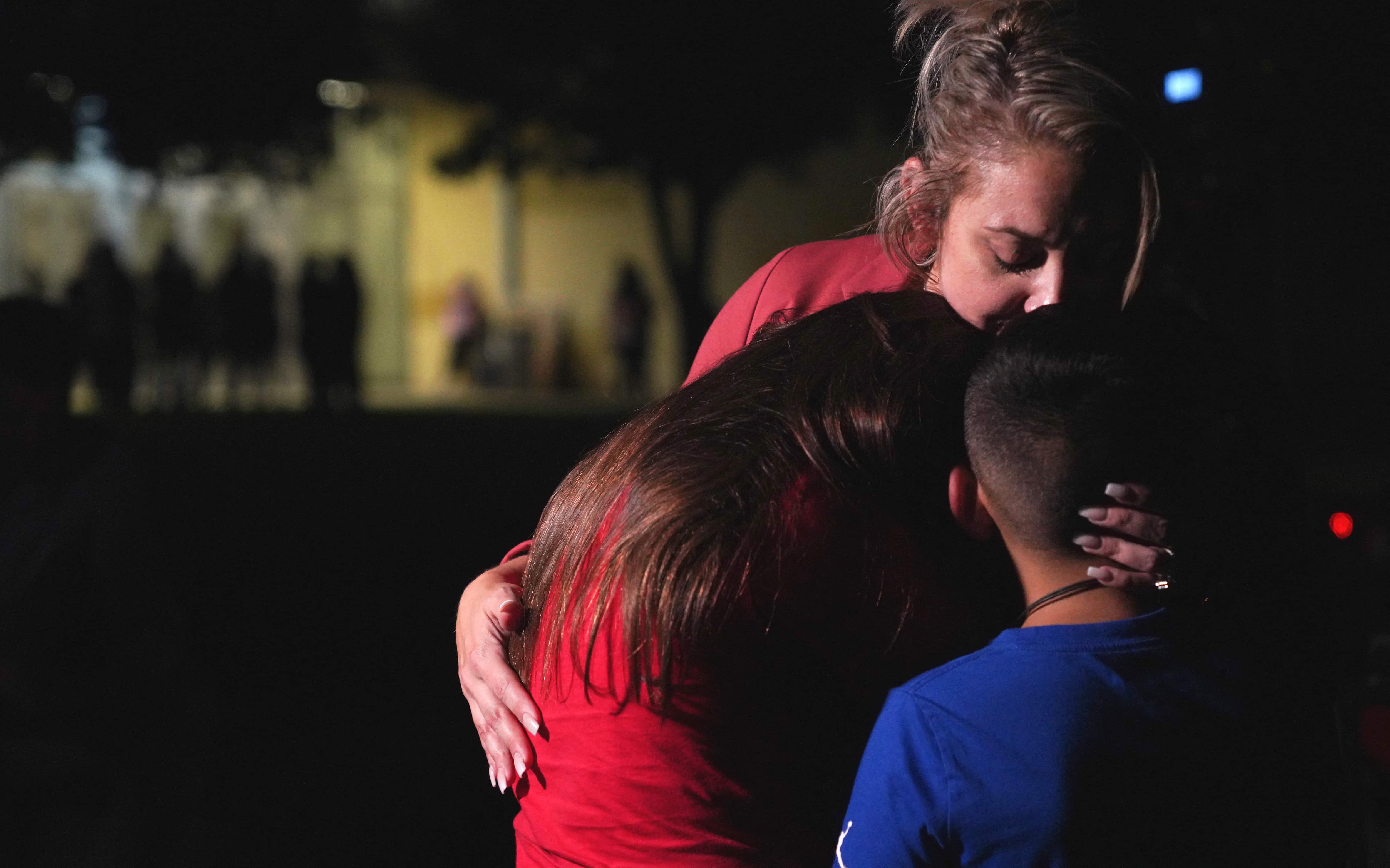 Families hug outside the Willie de Leon Civic Center in Uvalde, Texas, on May 24, 2022.