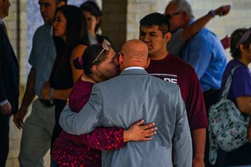 Mourners dressed in purple, colour of school