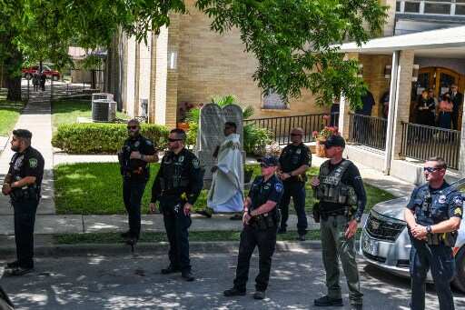 Police stand guard in front of Sacred Heart Church