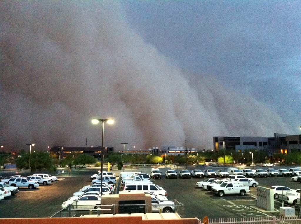 Skies darkened in central Phoenix as the monsoon brings rain, dust storm and lightning