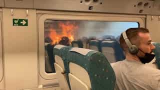 WATCH | Passengers in shock as train halts in middle of wildfire in Spain