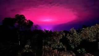 Aliens? Celestial phenomenon? Weed facility? Bizarre pink glow over an Australian town