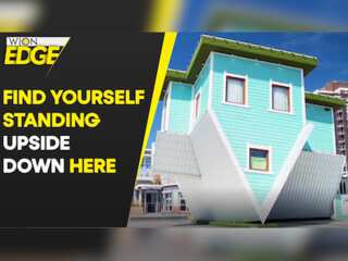 In this seaside house, people appear upside down