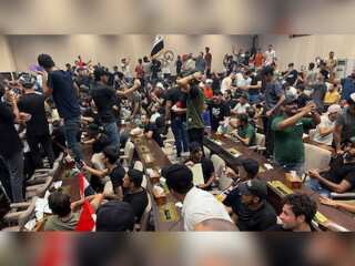 Protesters sing & dance inside the Iraq Parliament as the nine-month political paralysis continues