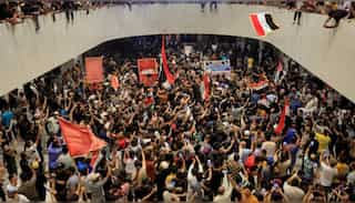 Protesters storm Iraq's parliament; Police fire tear gas & water cannon on protesters