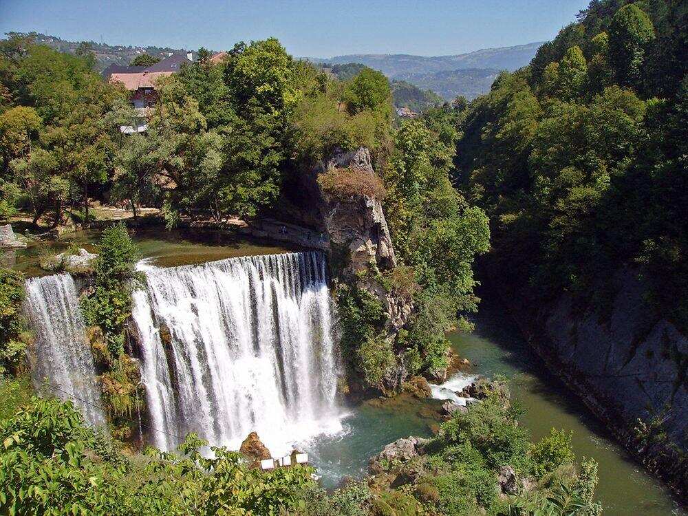 Spectators watch diving competition in rain as divers take plunge in Pliva waterfall