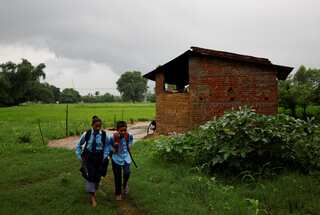 In Nepal, woman returns to school with her son to pick up from where she left off
