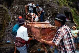 Indonesian villagers dig up corpses and clean them in afterlife ritual