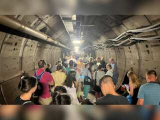 Passengers stranded inside an undersea tunnel, transferred to a rescue train
