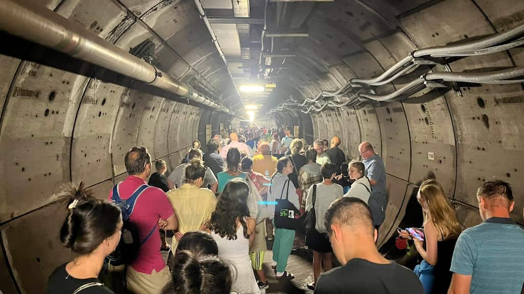 Passengers stranded inside an undersea tunnel, transferred to a rescue train