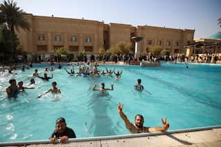 Iraqi protesters take dip in pool after storming presidential palace in Baghdad - WATCH