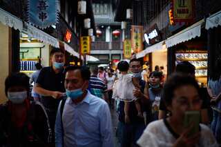 China plans to shorten COVID quarantine, Beijing amps up restrictions