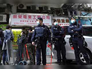Hong Kong charges harmonica player with sedition law at Queen vigil