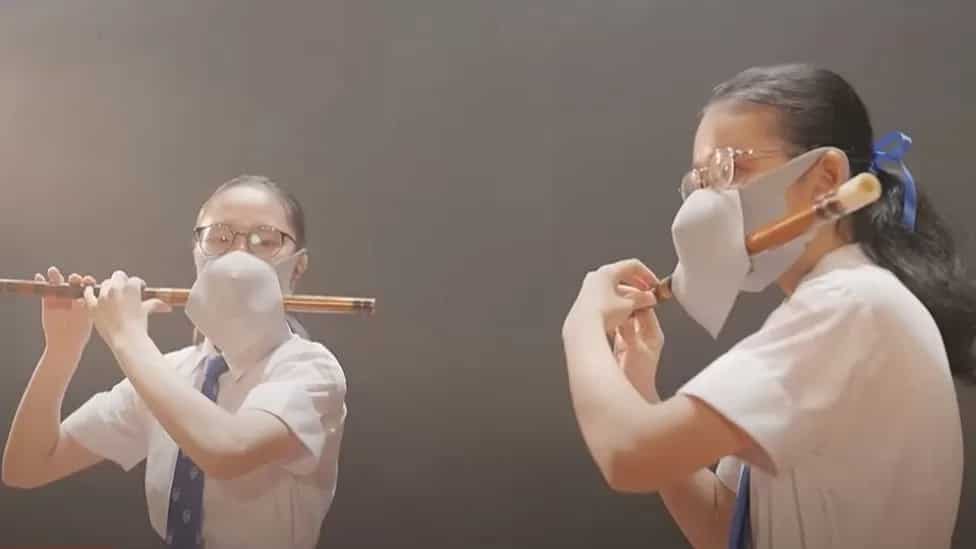 Double-masked Hong Kong flautist schoolgirls in ad draw ridicule on social media Double-masked Hong Kong flautist schoolgirls in ad draw ridicule on social media