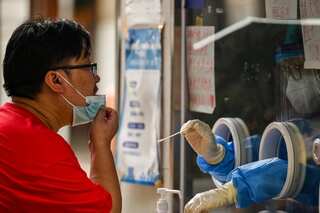 Chinese artist records COVID-19 tests from inside his mouth - WATCH
