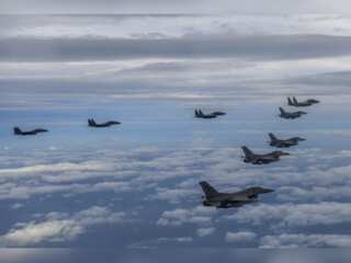 North Korea's fighter planes fly near border, tests another missile